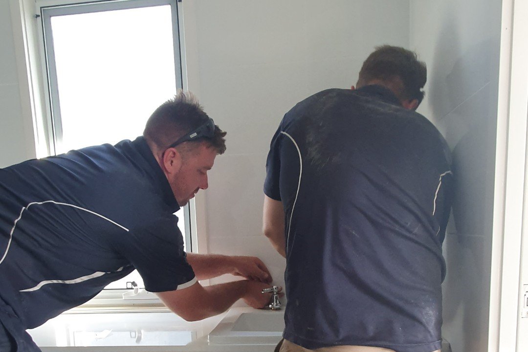 Image of plumbers working in a residential home